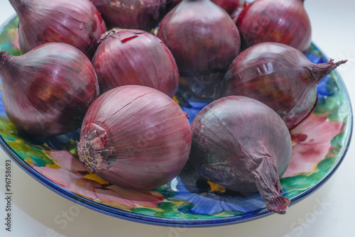 Bulbs of red onion on the plate