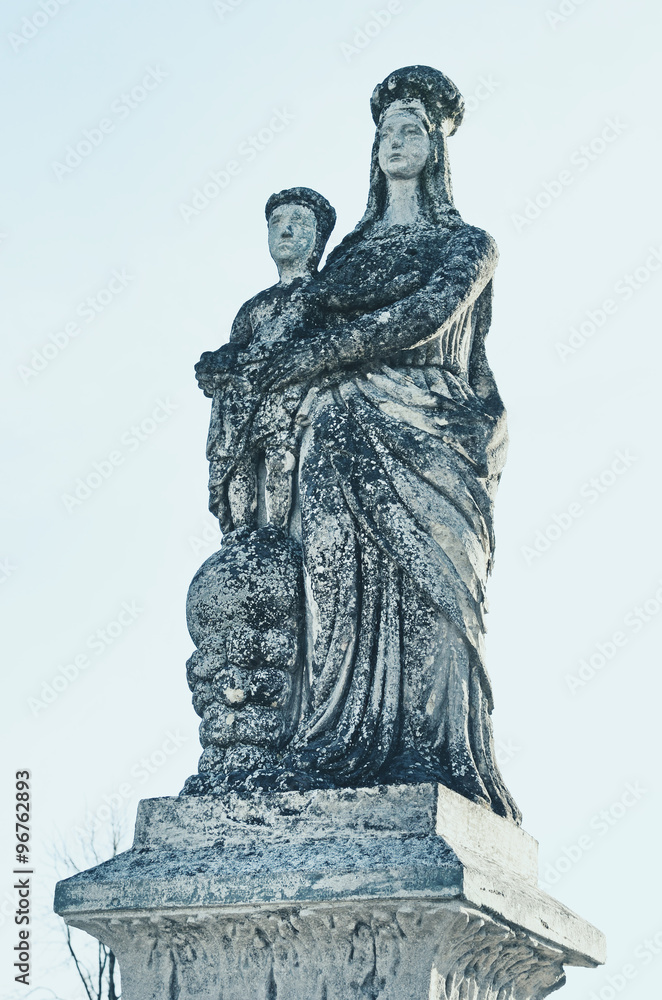 Old stone statue of the Virgin on tomb and Jesus Christ in the c
