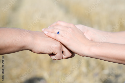Female's hands put over the male's hand © gorosi