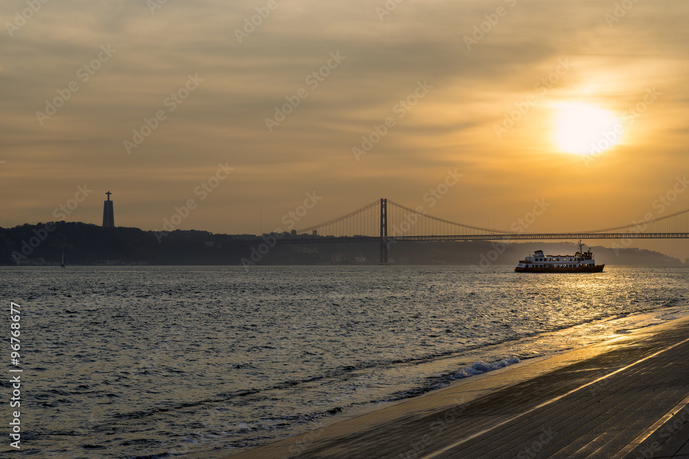 View of the bridge over the Tagus River (25 de Abril bridge) in Lisbon, Portugal, at sunset