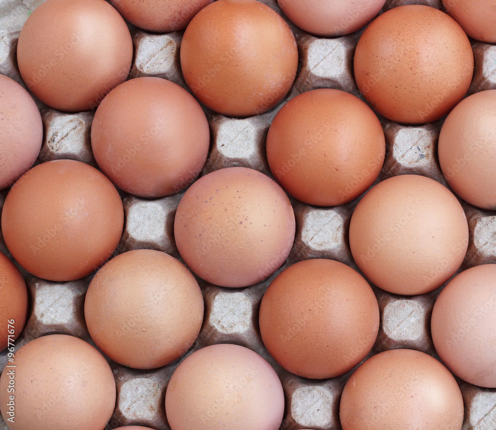 Chicken brown eggs in a tray, the top view. Chicken brown eggs in a tray, the top view.