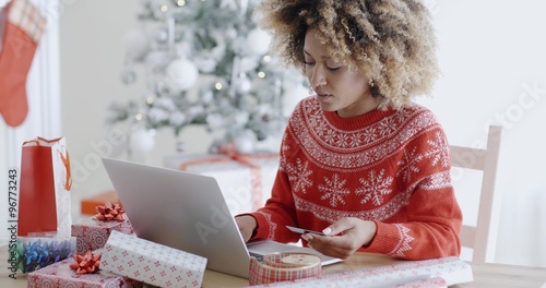 Young woman doing Xmas shopping online