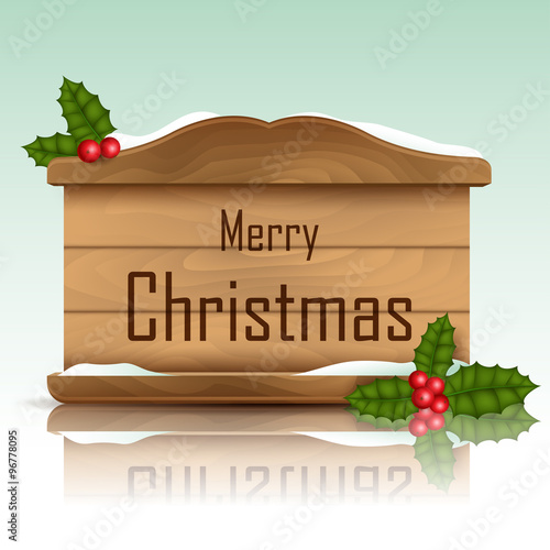 Christmas wood frame covered with snow, with holly decoration