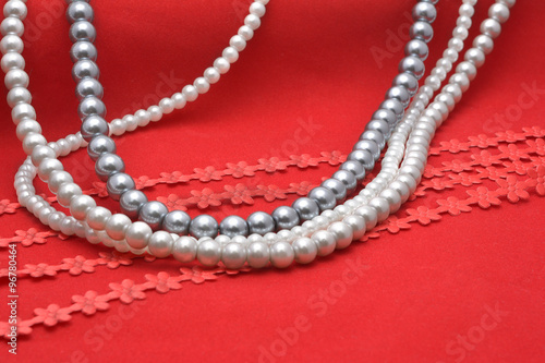 Pearl threads on red velvet 