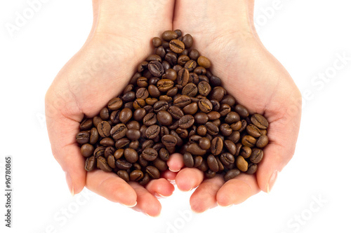 Heart symbol of bean coffee in feminine hand. Isolated on