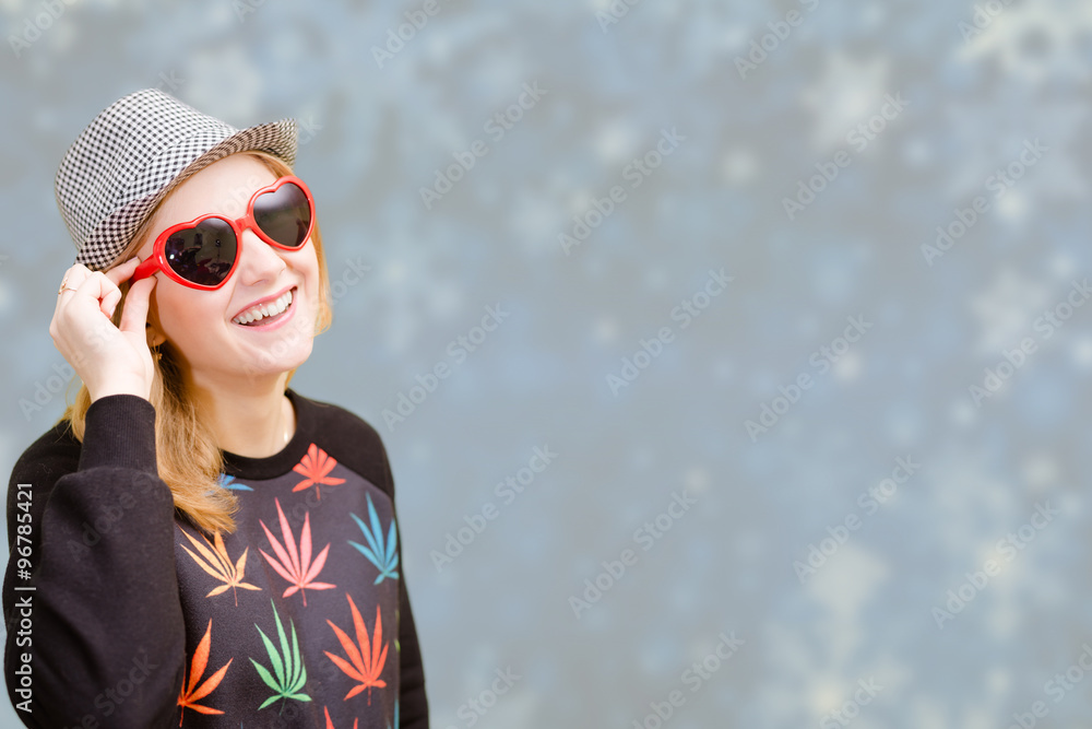 Beautiful woman in fancy sunglasses smiling on snowflakes blurred background Beautiful woman in fancy sunglasses smiling on snowflakes blurred background