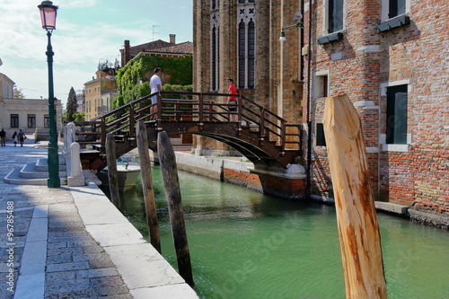 Canal Rio della Salute and bridge with tourists in Venice