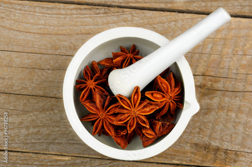 Star Anise in white mortar and pestle