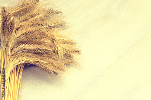 Photography ears of wheat on wooden background