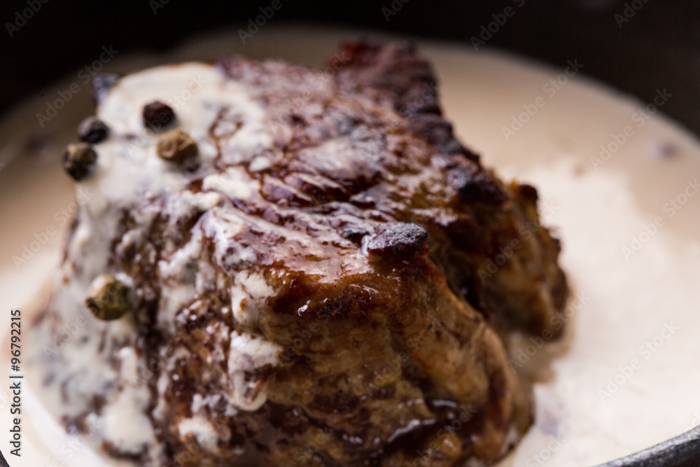 Fried meat in a pan in a creamy sauce