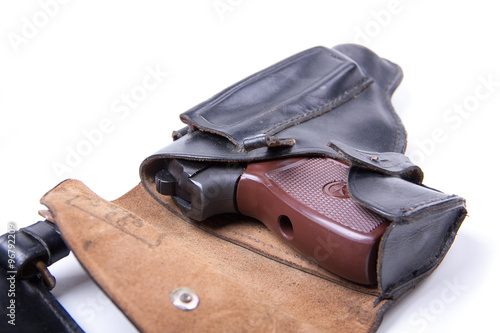 Leather holster with gun, isolated on white
