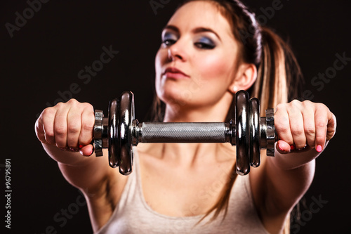athletic woman working with heavy dumbbells