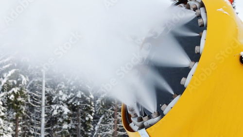 Snow machine gun on a ski slope. photo