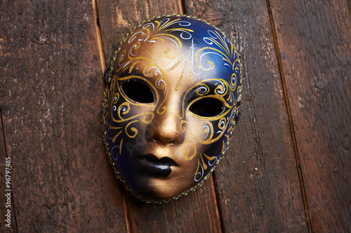 Venetian mask on a wooden table