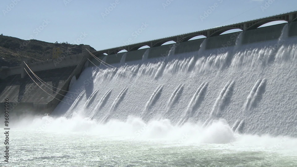 Wide shot of the spillway with power cables on the Grand Coulee hydroelectric dam in Washington, USA Wide shot of the spillway with power cables on the Grand Coulee hydroelectric dam in Washington, USA