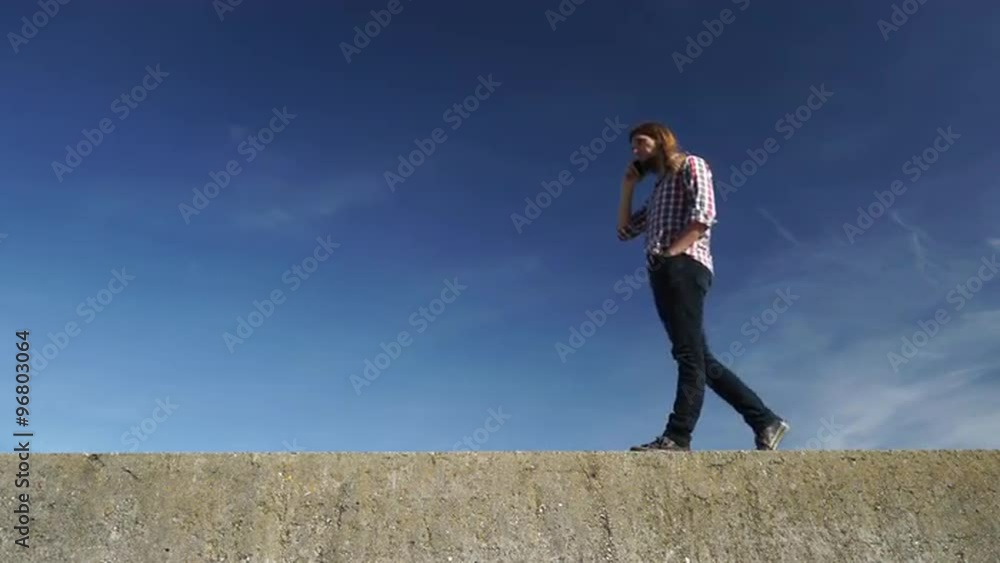 Man walking outdoor talking on cell phone 4K Man walking outdoor talking on cell phone 4K