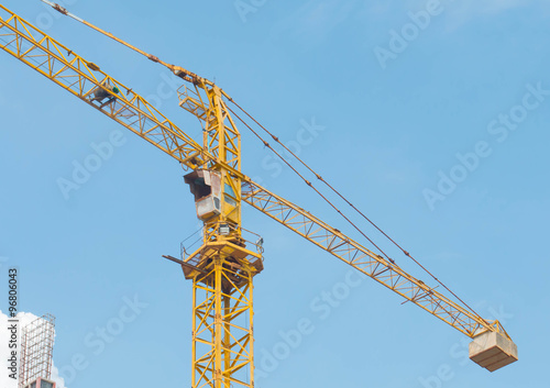 Construction site with cranes on sky background