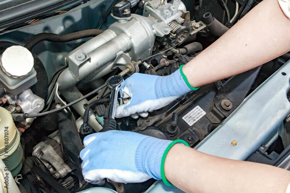 Fototapeta premium Spark plug replacement work