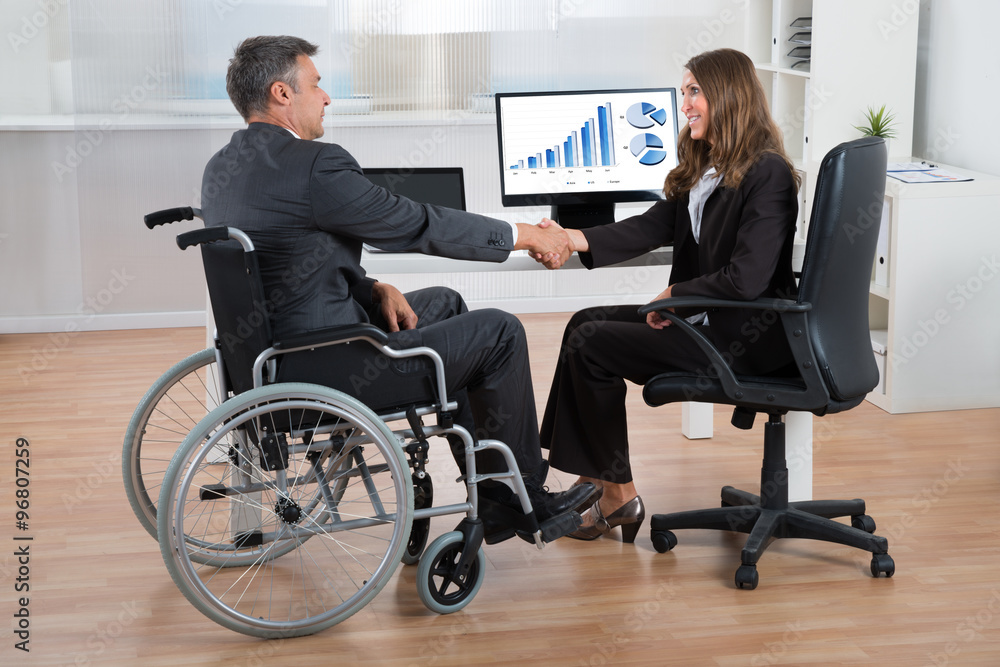Businesswoman Shaking Hands With Disabled Businessman Businesswoman Shaking Hands With Disabled Businessman