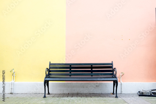 Black bench at colorful wall