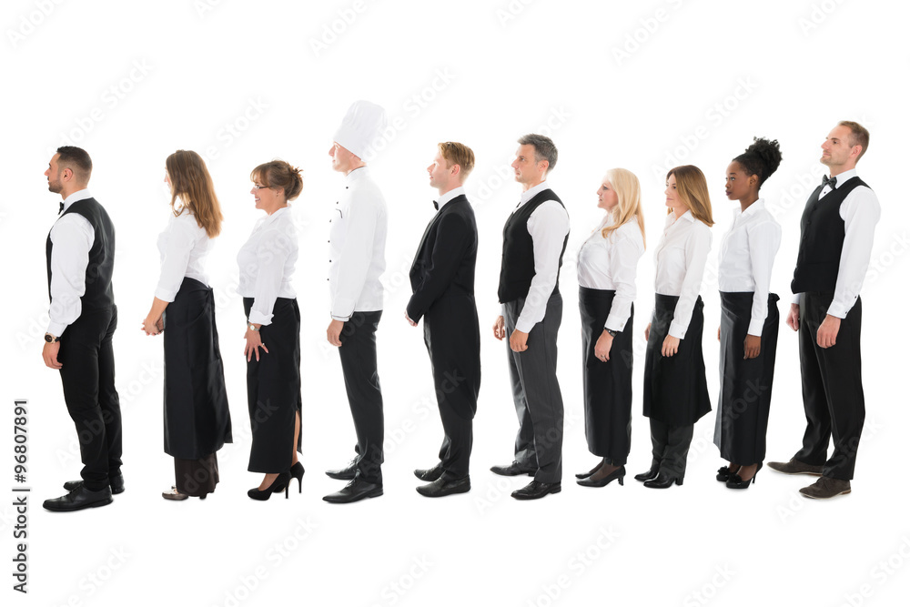 Side View Of Restaurant Staff Standing In Line Side View Of Restaurant Staff Standing In Line