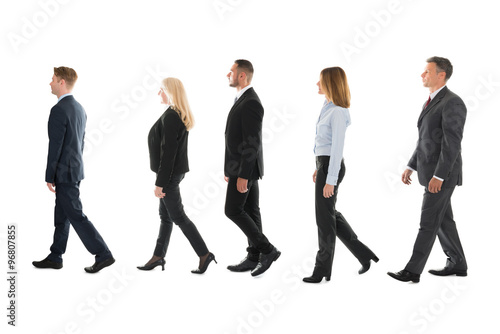 Business People Walking Against White Background