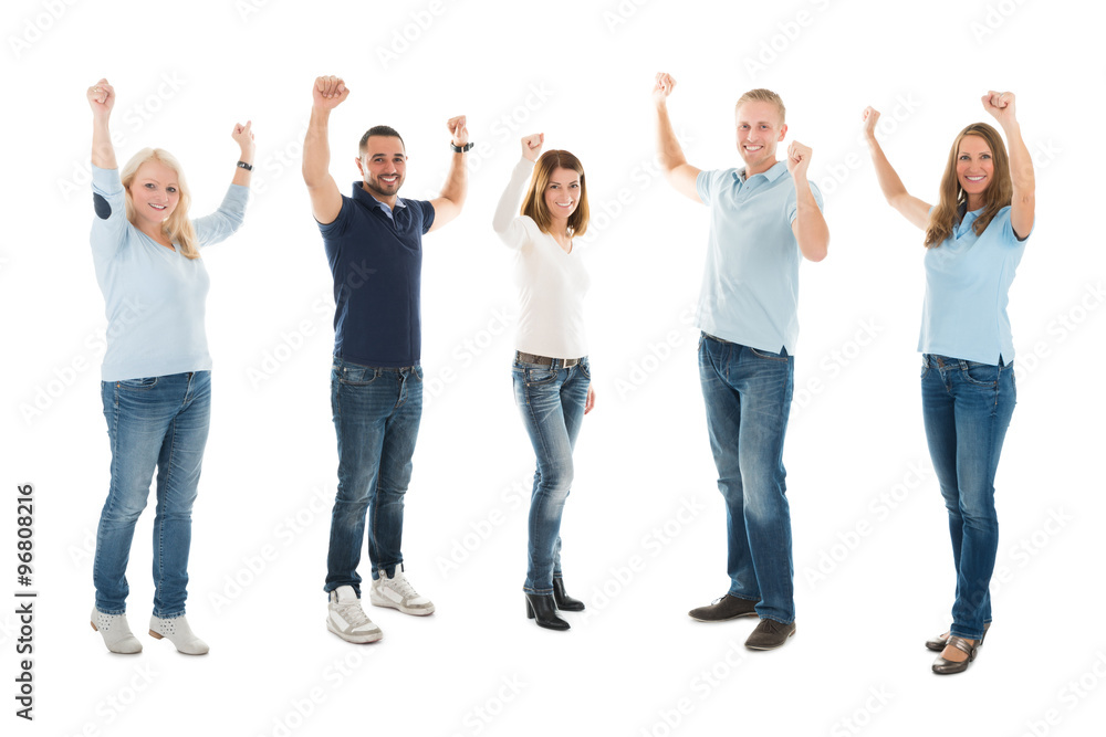 Confident People In Casuals Standing With Arms Raised Confident People In Casuals Standing With Arms Raised