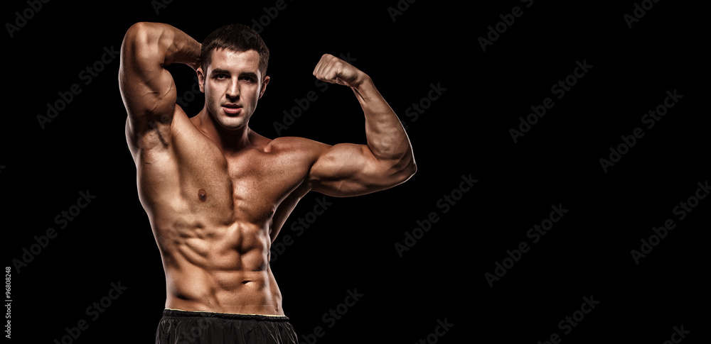Fototapeta premium Muscular Bodybuilder Guy Doing Exercises With Dumbbells