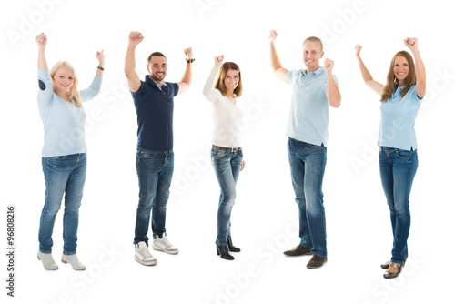 Confident People In Casuals Standing With Arms Raised