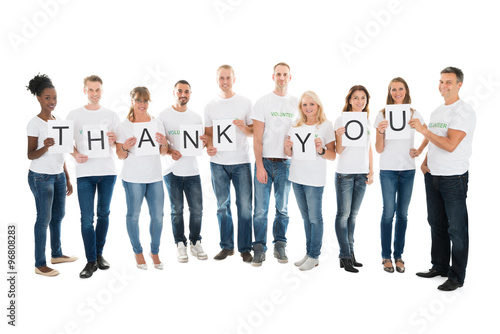 Confident Volunteers Showing Thank You Sign