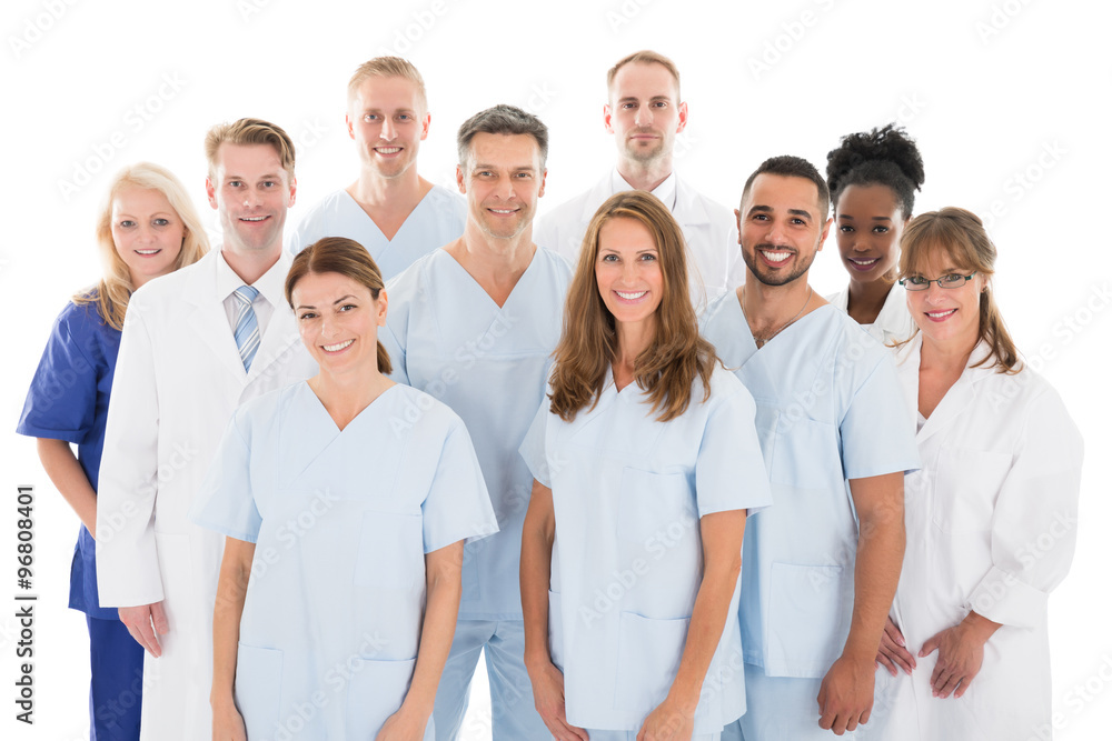 Obraz premium Happy Medical Team Standing Against White Background