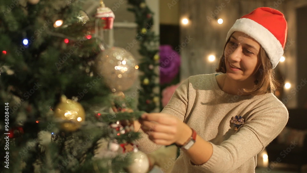 Two beautiful girls decorate a Christmas tree Two beautiful girls decorate a Christmas tree