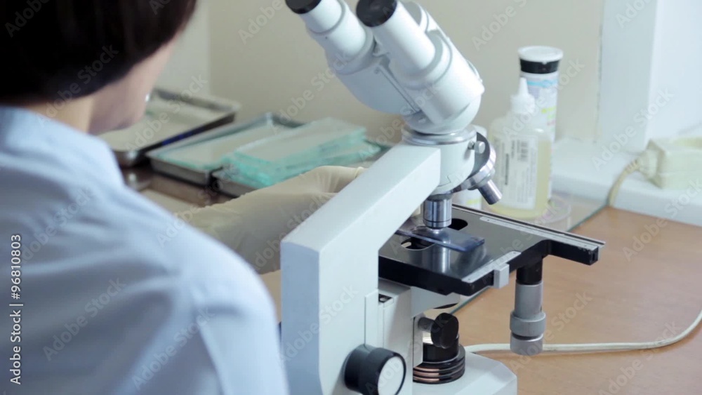 Doctor working In Lab With Microscope