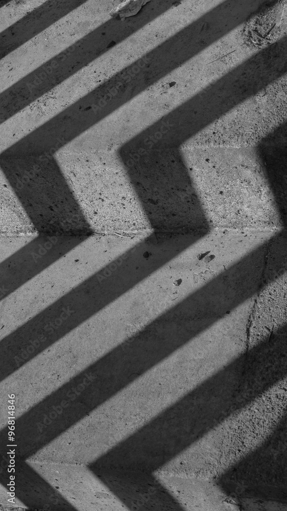 black and white photo of stairs with winding shadow of bannister