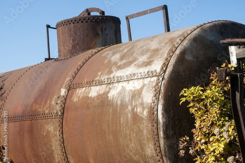 Old vintage weathered grunge abandoned train fuel and oil railway tank