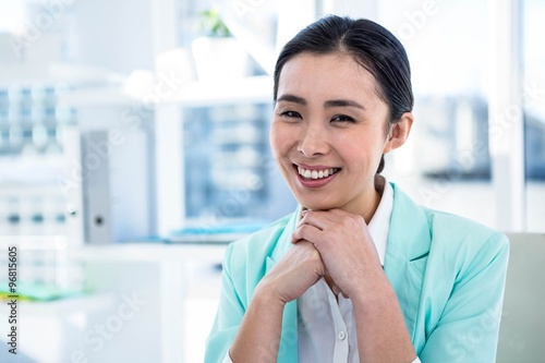 Smiling businesswoman at her desk