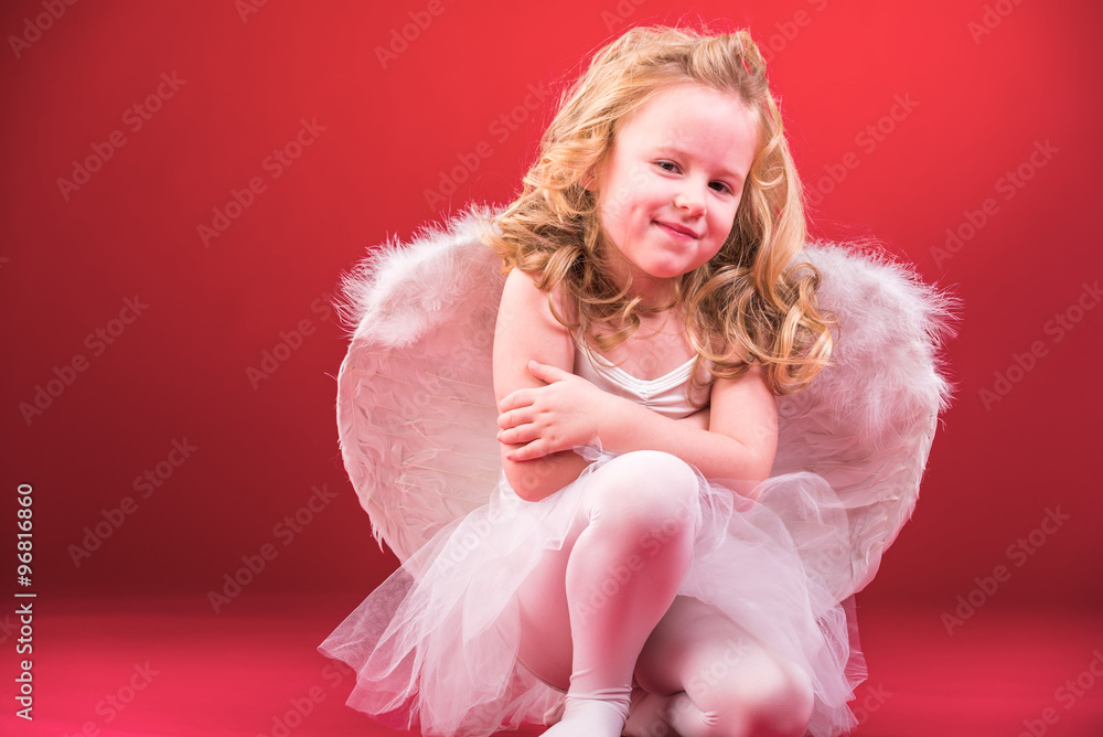 Beautiful blond hair angel on a red background Beautiful blond hair angel on a red background