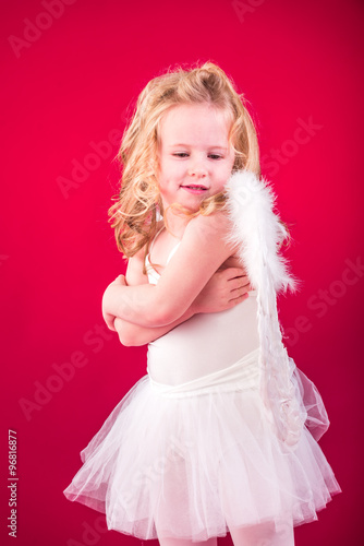 Beautiful blond hair angel on a red background