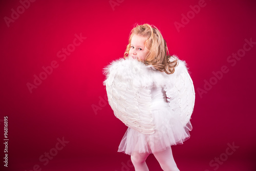 Beautiful blond hair angel on a red background