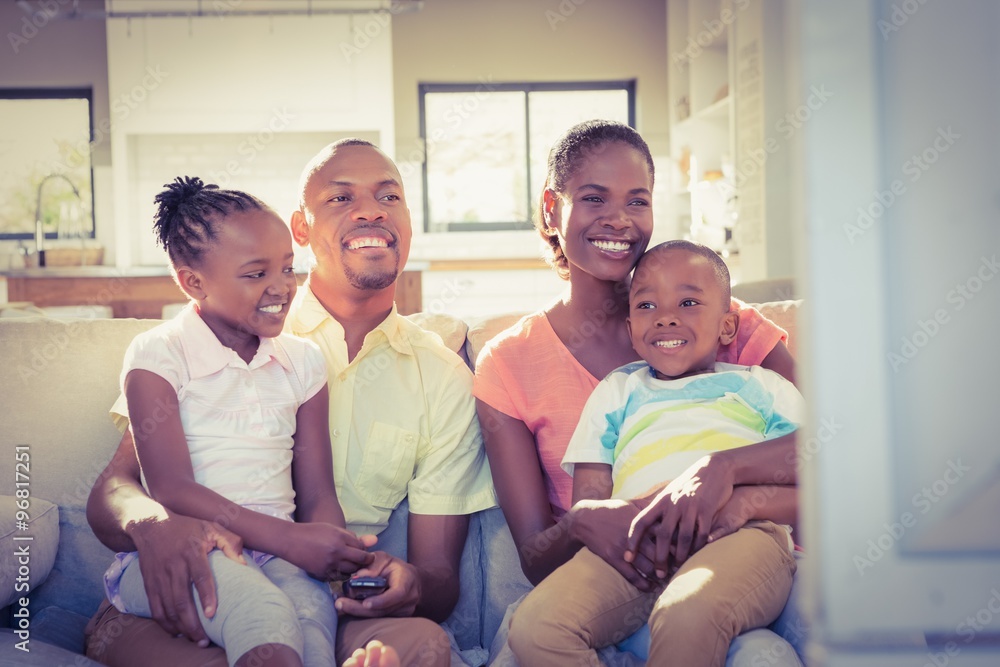 Portrait of a family of four watching tv