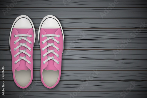 Pink gumshoes Shoes on wooden background