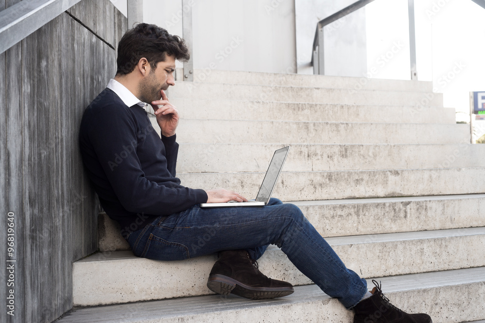 young man with computer and doubts young man with computer and doubts