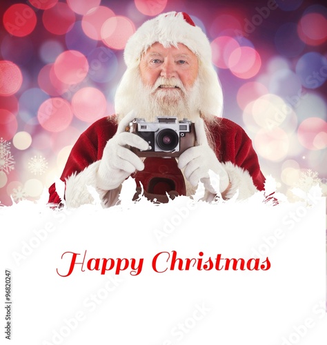 Composite image of santa is taking a picture photo