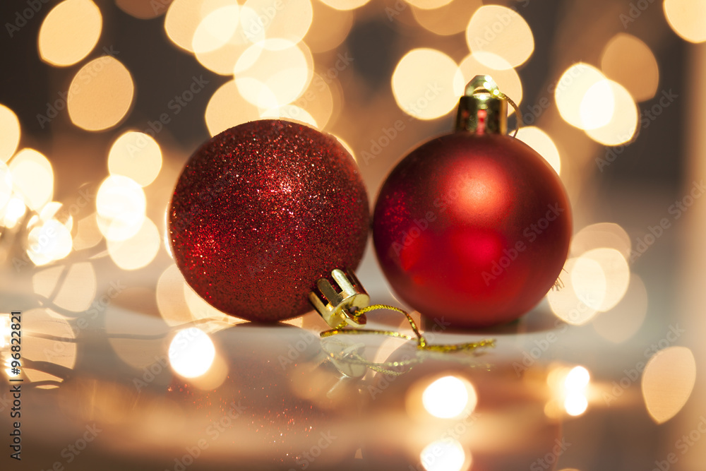 Two red christmas balls with blurred light background Two red christmas balls with blurred light background