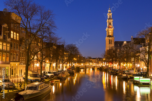 Photography The Western Church and a canal in Amsterdam at night