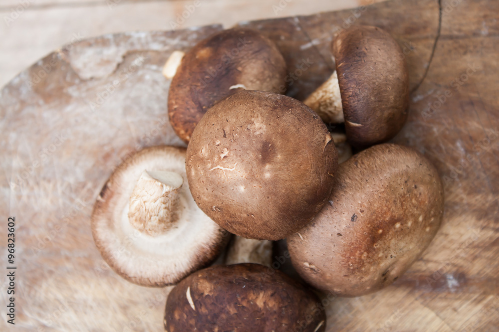 Shiitake mushrooms on wood background Shiitake mushrooms on wood background