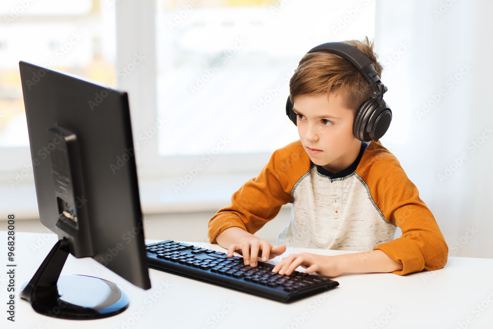 boy with computer and headphones at home boy with computer and headphones at home