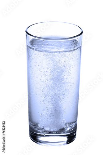 tablet in glass of water isolated on white