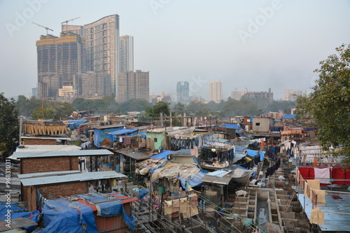 Obraz na plátně Mumbai, India - October 19, 2015 - Muslim washing spot Dhobi Ghat in front of Mumbai skyline