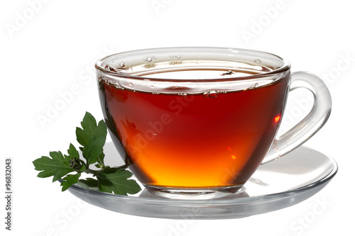 Cup tea and green leaf on white